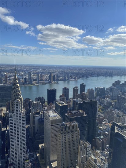 Daytime view of a large city with a view of the river and numerous skyscrapers, including the