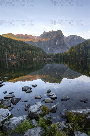 Mountain peaks of the Oetztal Alps reflected in Lake Piburger See, in autumn, near Oetz in Oetztal,