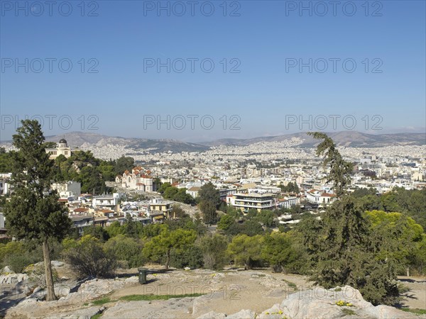 City view from a hill surrounded by buildings and trees, Ancient buildings with columns and trees