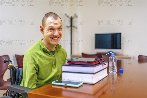 Man with disability sitting in wheelchair in the study room of the university