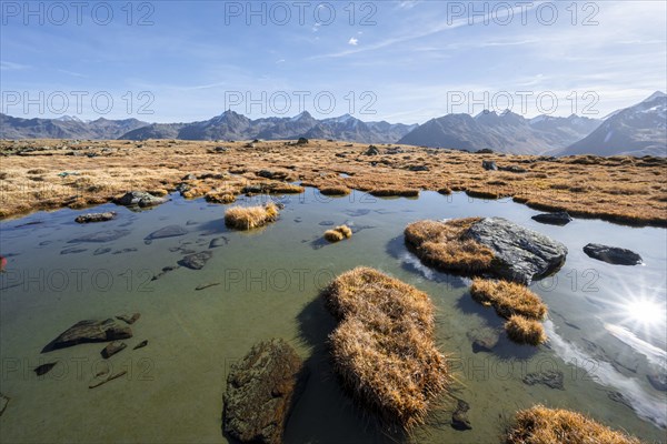 Small lake on the high plateau of the Gurgler Seenplatte, glaciated mountain peaks in the