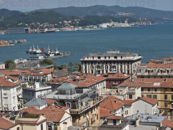 City panorama with red roofs, view of harbour and hills in the distance on a sunny day, Bari,