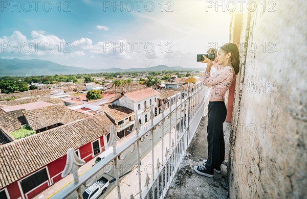 Tourist photographing the streets of Granada from the La Merced viewpoint. Tourist girl taking