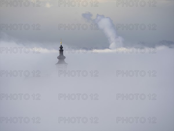 Church tower rises out of the morning mist, Frauenberg pilgrimage church, near Leibnitz, Styria,