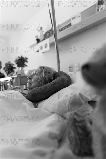 Senior citizen with dementia lying in her room in a retirement home, portrait, Baden-Wuerttemberg,