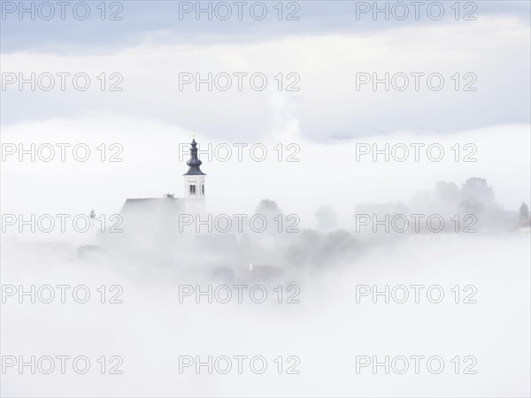 Church rises out of the morning mist, Frauenberg pilgrimage church, near Leibnitz, Styria, Austria,