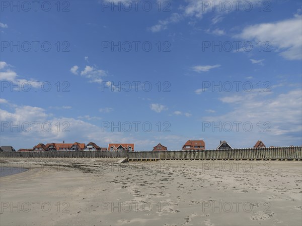 Coastal landscape with a wide beach and traditional houses, Baltrum Germany
