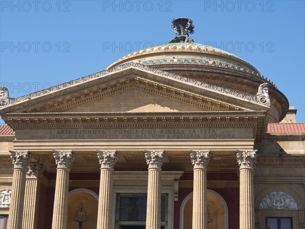 Historic building with magnificent dome and columns in front of a cloudless blue sky, palermo in