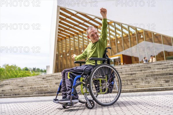 Disabled man in wheelchair proud celebrating he achieve to go to the university