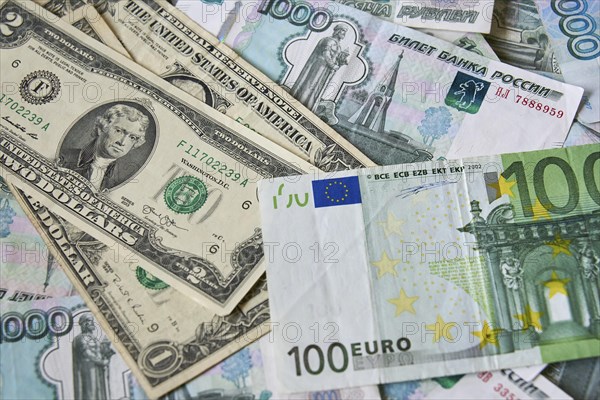 Background of paper bills dollars, euros and rubles. Currency exchange rate