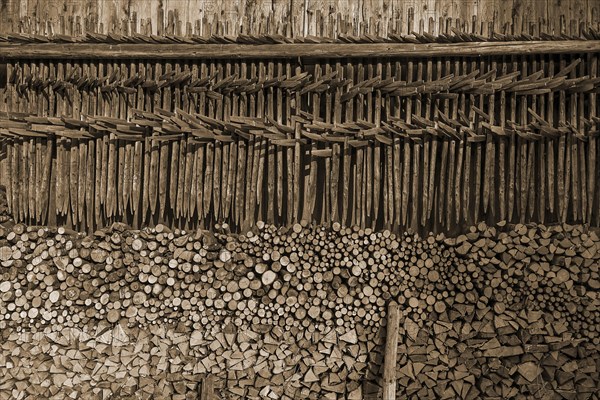 Stacked firewood and hanging hay, hay dryer at a barn, Bad Oberdorf, Allgaeu, Bavaria, Germany,