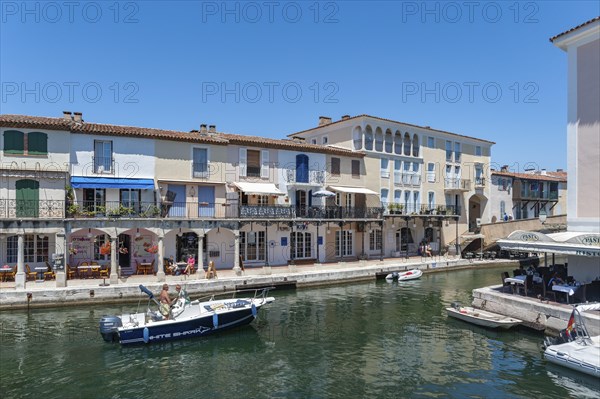 Townscape with restaurants and shops at the Pont principal du port grimaud, Port Grimaud, Var,