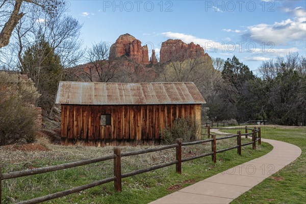Cathedral Rock sandstone formations tower over a rustic barn at the Crescent Moon Picnic Site in