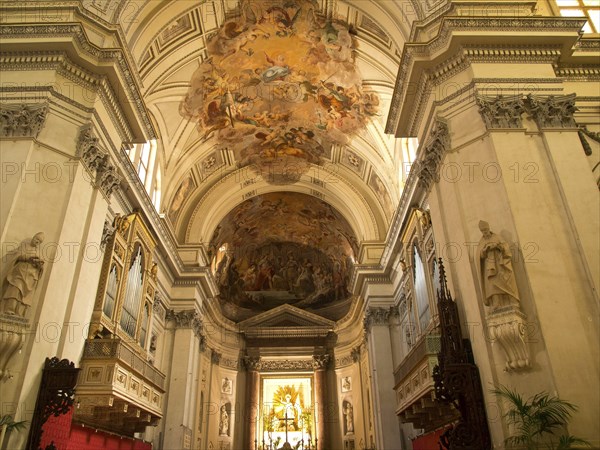 Magnificent church interior with ornate ceiling frescoes and decorative elements in a warm
