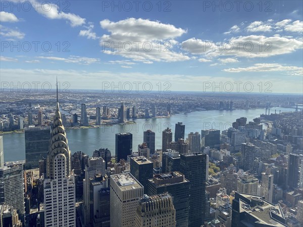 Daytime view of a large city with a view of the river and numerous skyscrapers, including the