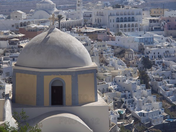 Elevation overlooking a town of white buildings and a large dome, typical of Mediterranean towns,