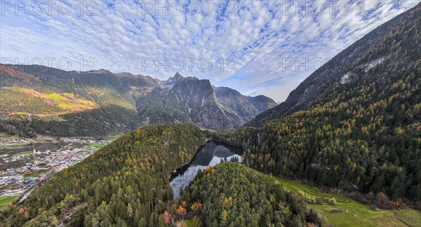 Aerial view, mountain peaks of the Oetztal Alps reflected in Lake Piburger See, in autumn, near
