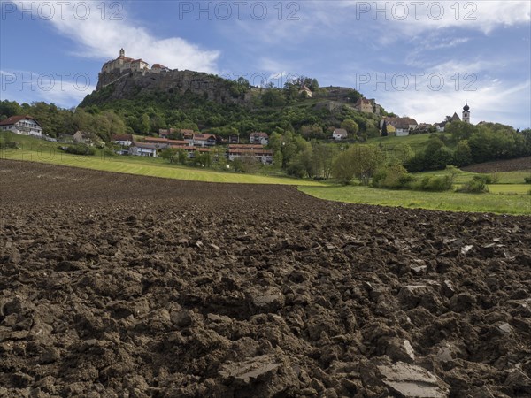 Clods of earth in farmland, Riegersburg Castle in the background, near Riegersburg, Styria,