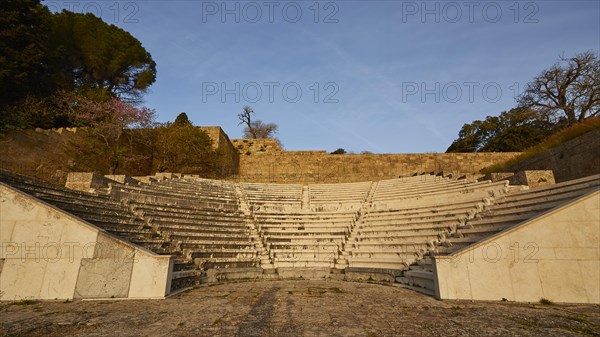 Ancient amphitheatre with stone seating steps, captured in the morning light, Archaeological site,