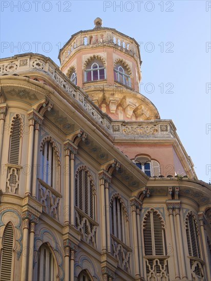 Pink building with decorative elements and a tower with shutters, palma de Majorca with its