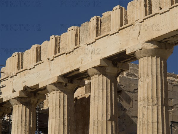 Side view of an ancient temple with columns in bright light and clear sky, Ancient buildings with