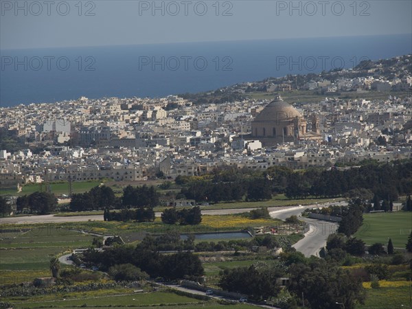 Panoramic view of a town near the sea with a striking dome and mediterranean buildings, the town of