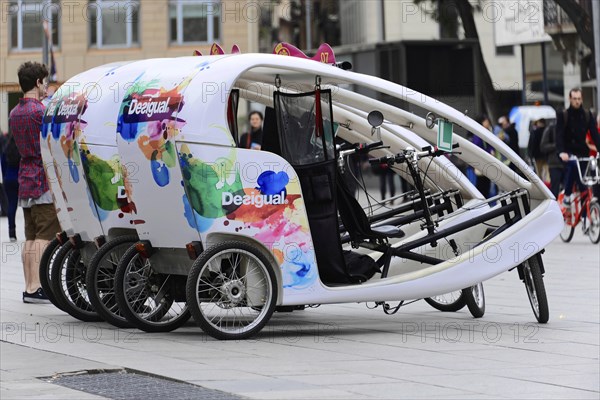 Barcelona, Catalonia, Spain, Europe, A colourfully painted bicycle tricycle for tourists in a city,