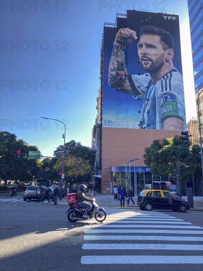 Street scene with giant mural showing Lionel Messi in winning pose, Buenos Aires, Argentina, South