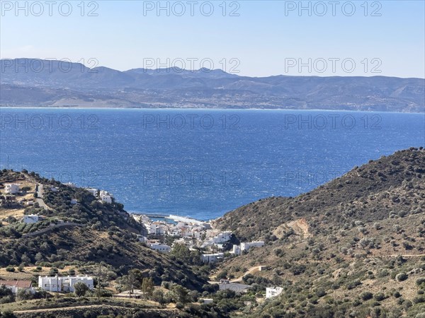 View of in the foreground former fishing village with sheltered safe harbour on the south coast of