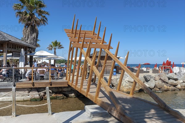 Modern wooden bridge on the beach Plage de Port Grimaud, Port Grimaud, Var, Provence-Alpes-Cote d