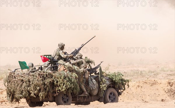 Dutch soldiers on a camouflaged Serval during the NATO Steadfast Defender large-scale manoeuvre in