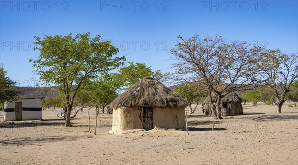 Mud huts in a village of the Hakaona, Angolan tribe of the Hakaona, near Opuwo, Kunene, Namibia,