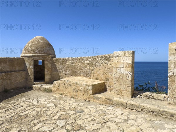Round watchtower and wall with crenellated gap for guns one of 10 round watchtowers of historic
