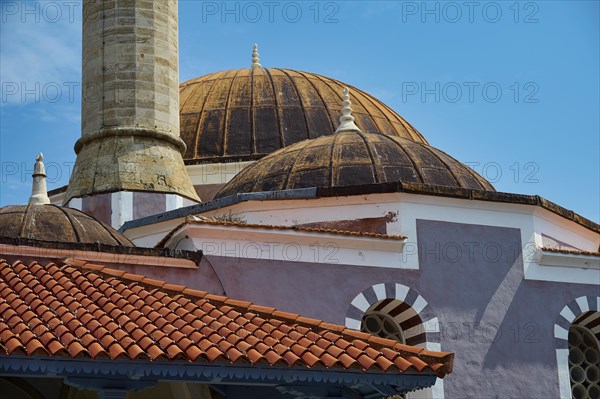 Suleiman Mosque, detailed view of historic domed building and minaret with red roofs under blue