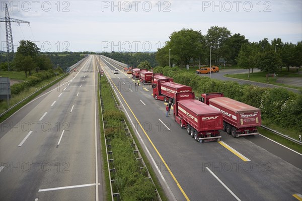 Trucks with a total weight of 960 tonnes stand on the Moselle valley bridge in Winningen during a