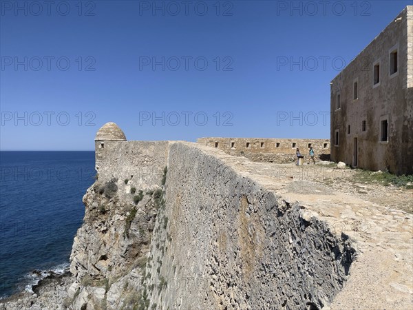 Left round watchtower and fortress wall on Mediterranean coast right part of house of councillors