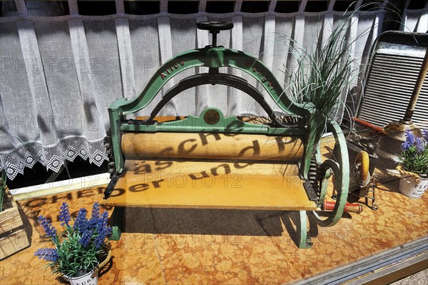 Shop window of a laundry with old mangle and washboard, Kempten, Allgaeu, Bavaria, Germany, Europe