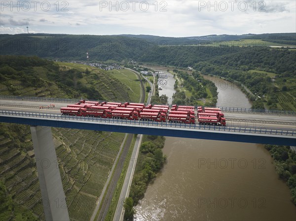 Trucks with a total weight of 960 tonnes stand on the Moselle valley bridge in Winningen during a