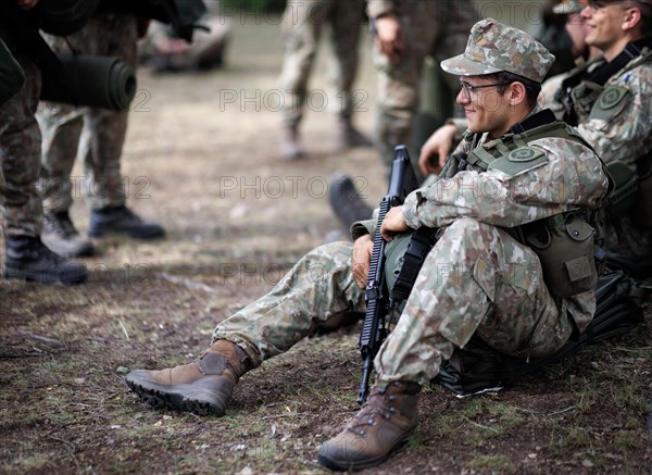 Young Lithuanian reserve soldiers take a lunch break during their training, taken in Rudninkai,
