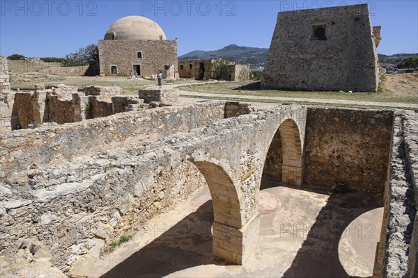 View of exposed walls columns in basement of former storage rooms of in ruins fortress ruins of