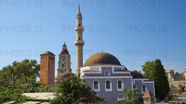 Suleiman Mosque, Historic buildings with minaret and domes, red roofs and trees under a cloudy sky,