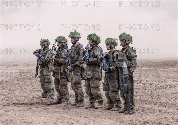 The crew of a Cougar infantry fighting vehicle presents itself at the NATO large-scale manoeuvre