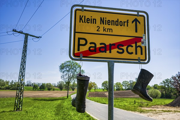 Boots on town sign, farmers' protest, Paarsch, Rome, Mecklenburg-Western Pomerania, Germany, Europe