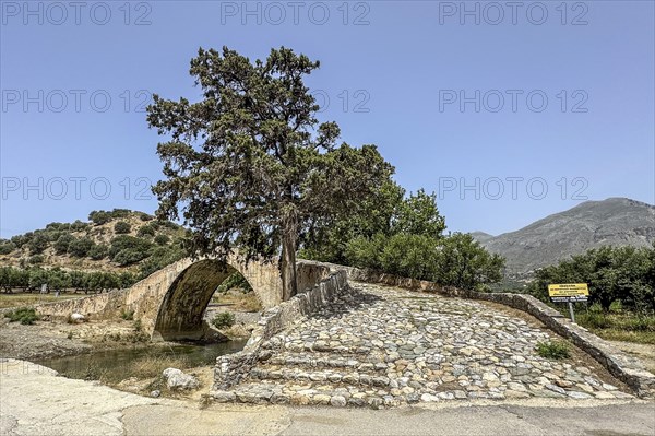 View of stairway with coarse cobblestones of historic classical arched stone bridge in Venetian