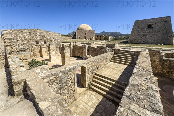 View of exposed walls columns of former storerooms and stairs to basement of old warehouse and