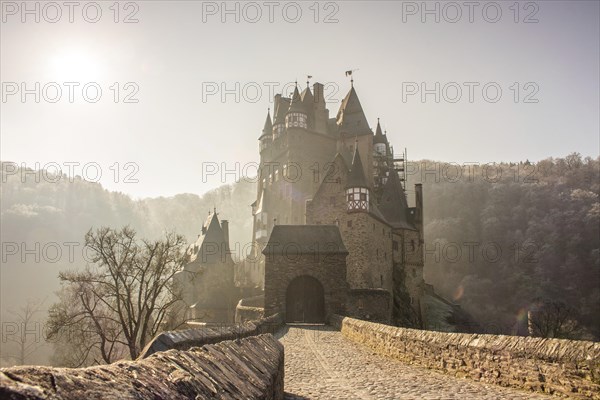 View of Eltz Castle. A landscape in autumn on a frosty morning with ripe and fog. The famous castle