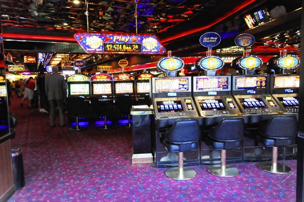 Las Vegas, Nevada, USA, North America, Row of slot machines in a colourfully lit casino, Las Vegas