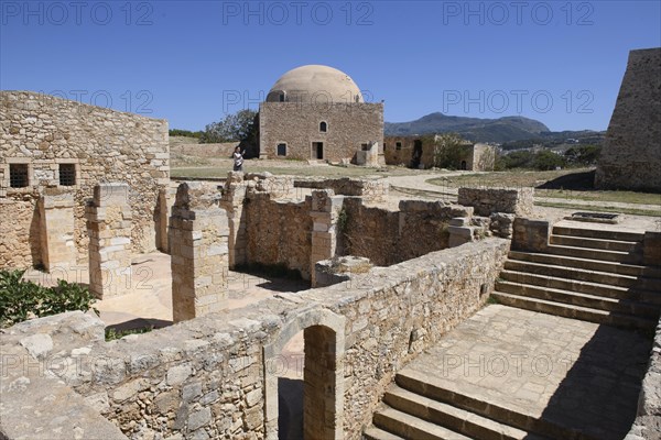 View of exposed walls columns of former storage rooms and stairs to basement of old warehouse in