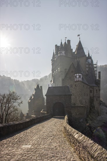 View of Eltz Castle. A landscape in autumn on a frosty morning with ripe and fog. The famous castle