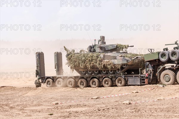 A Cougar infantry fighting vehicle is unloaded from a Mammut heavy goods transporter during the